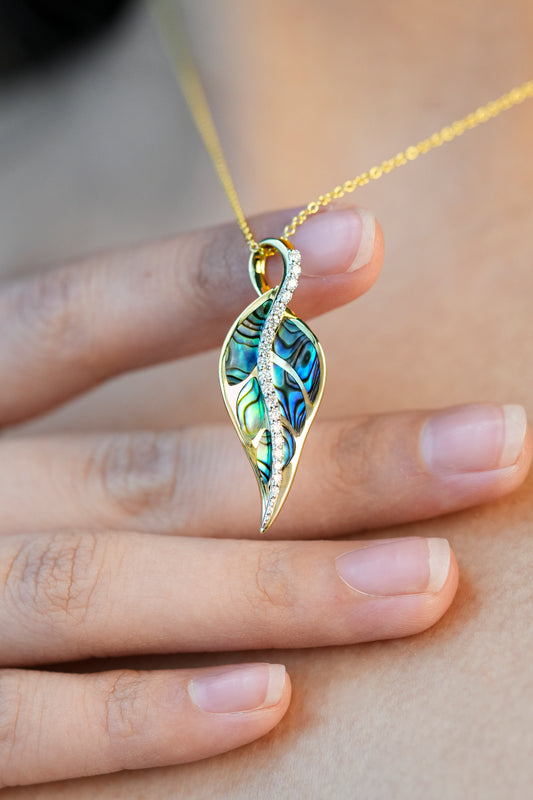 Model wearing and showing a Maile leaf-shaped pendant with Abalone inlay and diamonds - 44485
