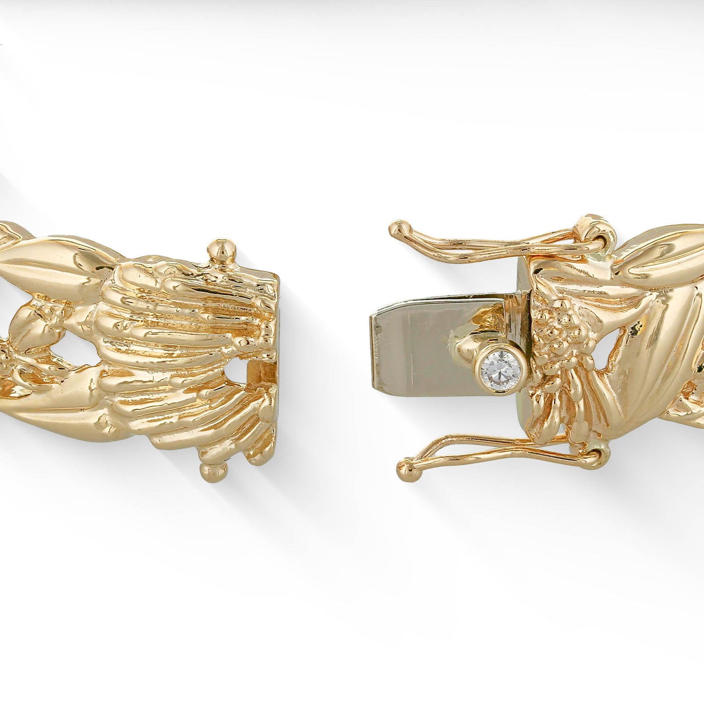 Close up of the yellow gold bracelet with white gold tongue in open box clasp and a diamond bezel button. Item No. 41516