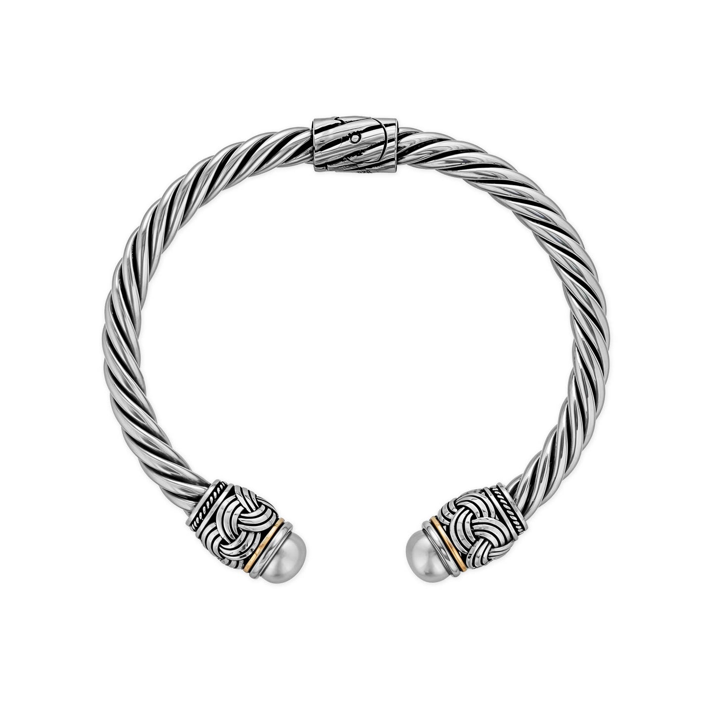 Viewed from above, a sterling silver twisted cuff bracelet showcases pearl end caps & mixed metal accents. Item No. 700678
