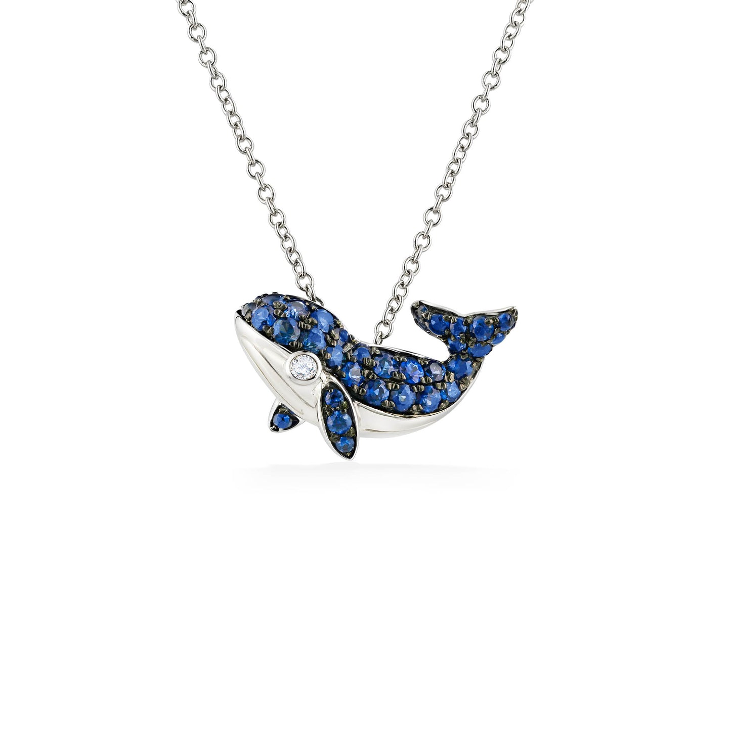 Cute whale pendant in 14k white gold with blue sapphire fins and backside, and a diamond eye. Item No. 771995