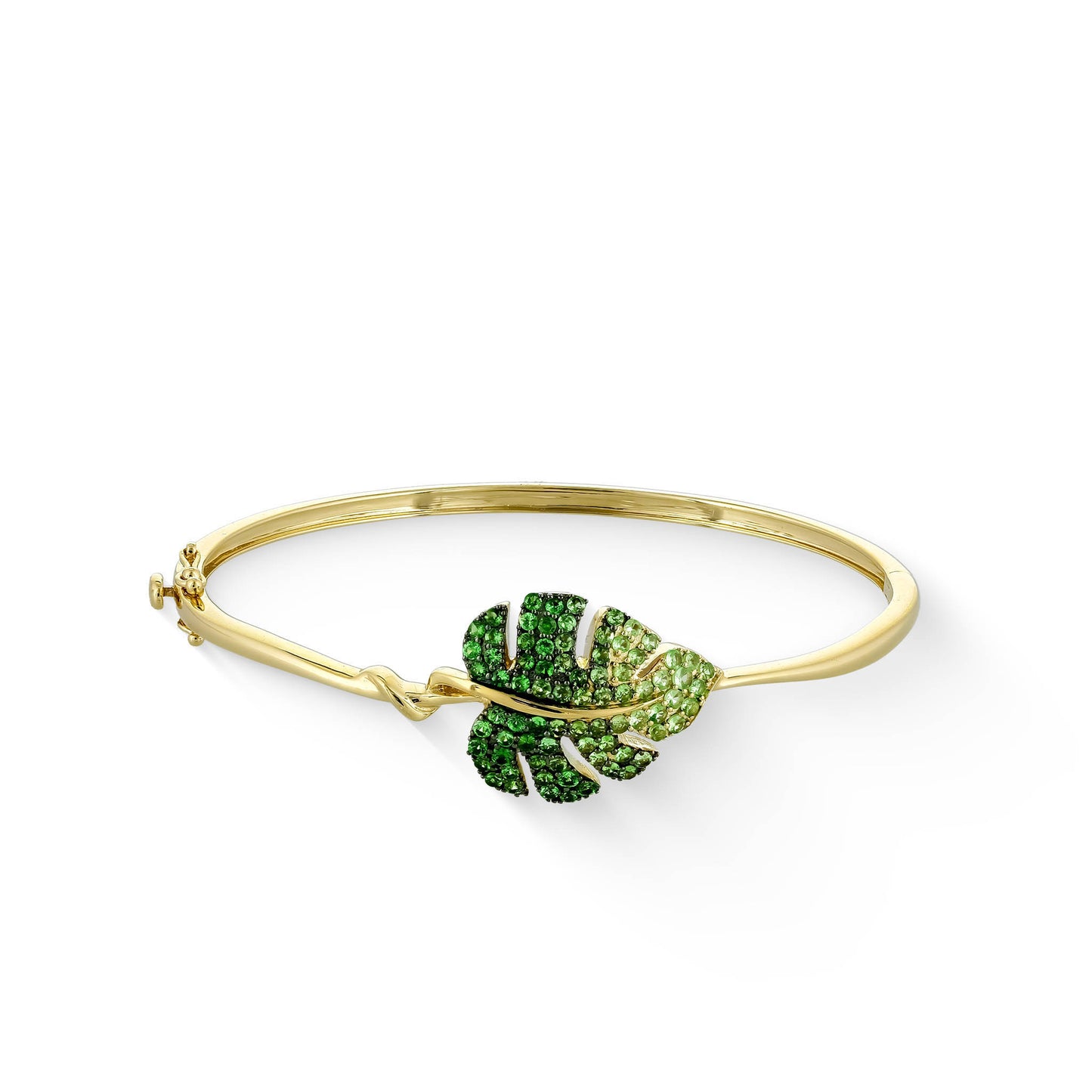 Gold bangle bracelet with a gradient tsavorite gemstone monstera leaf detail at the center. Item No. 773500