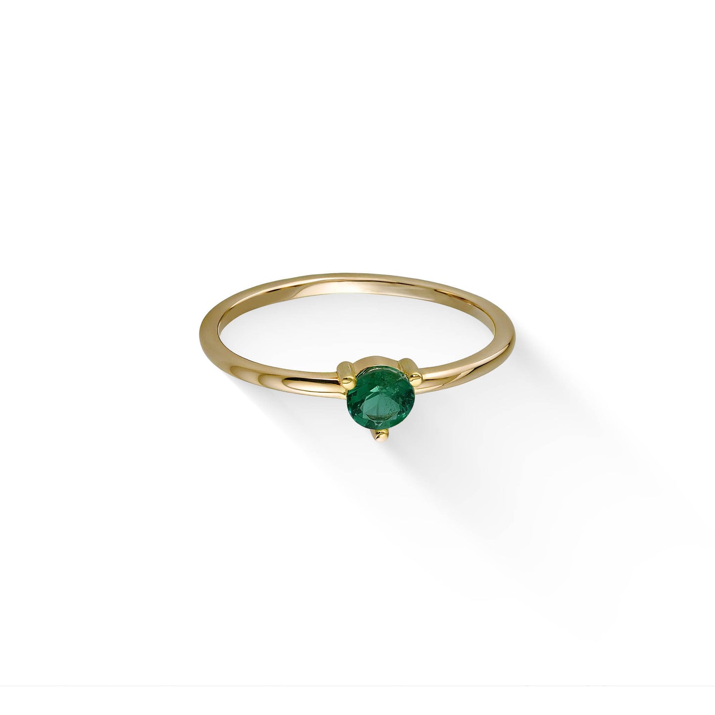 Top-down view of a slim yellow gold celestial ring showcasing a vivid green 3mm emerald centerpiece. Item No. 44790