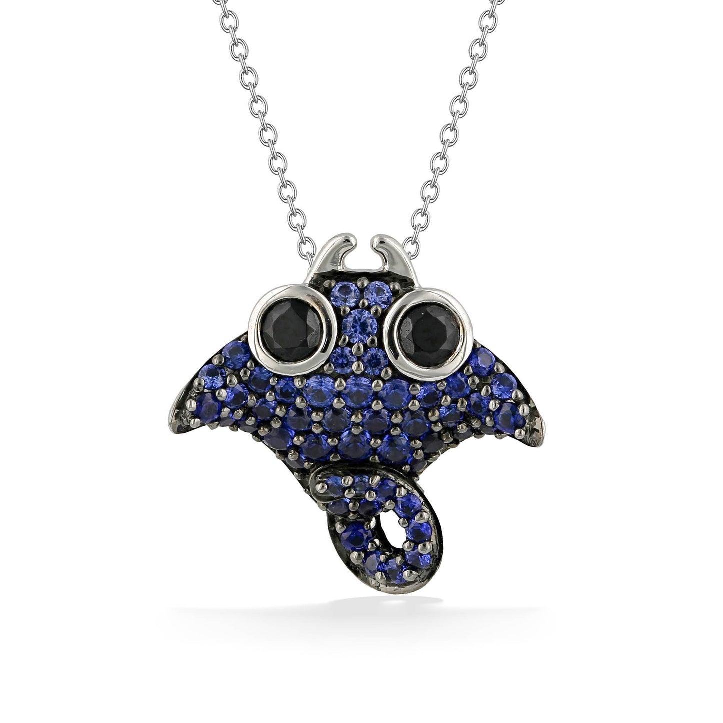 Baby Manta Ray pendant with blue sapphire detailed body and black spinel eyes, made in 14k white gold. Item No. 44731