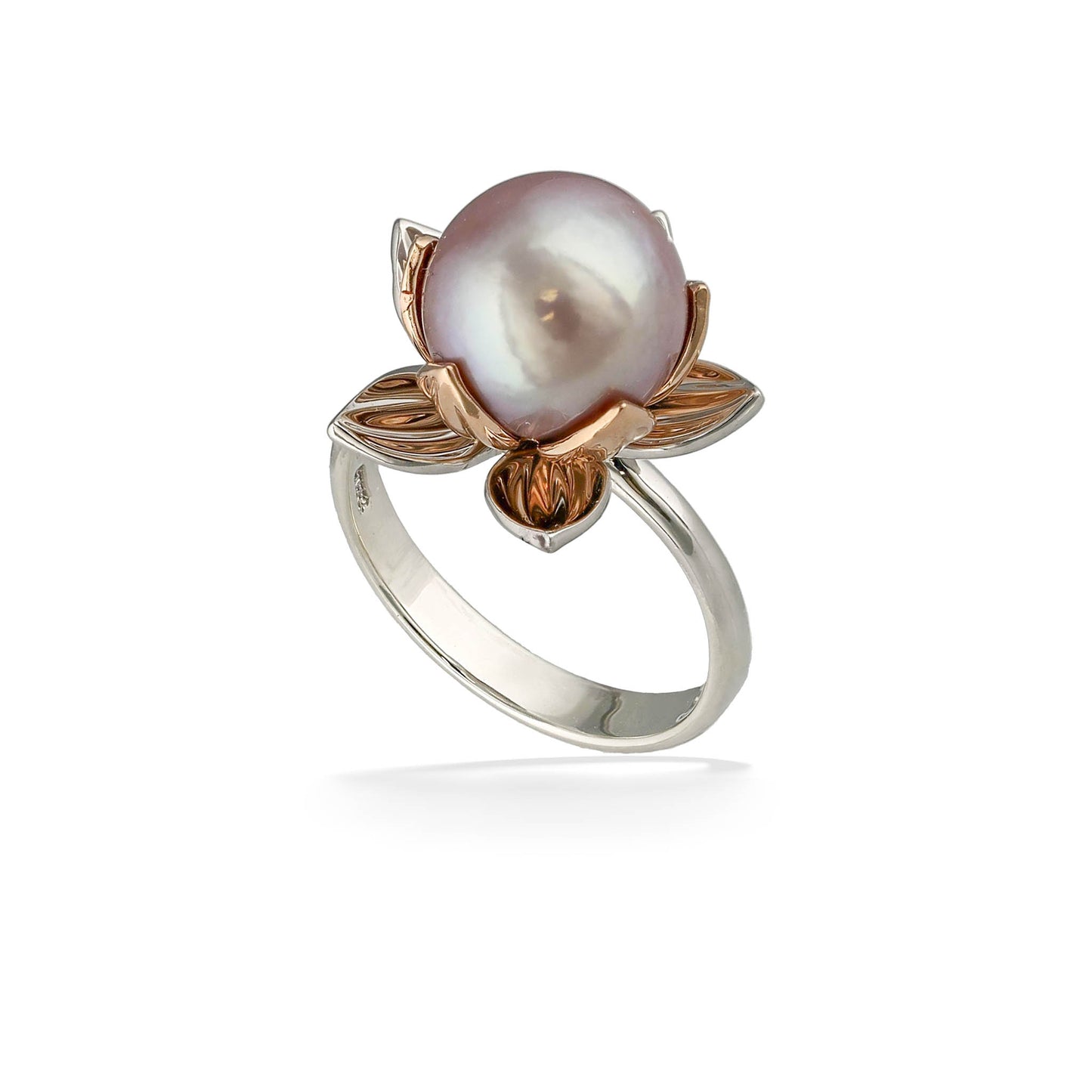 A luminous pink freshwater pearl rises from petal-like metalwork in a mixed tone floral statement ring. Item No. 45051