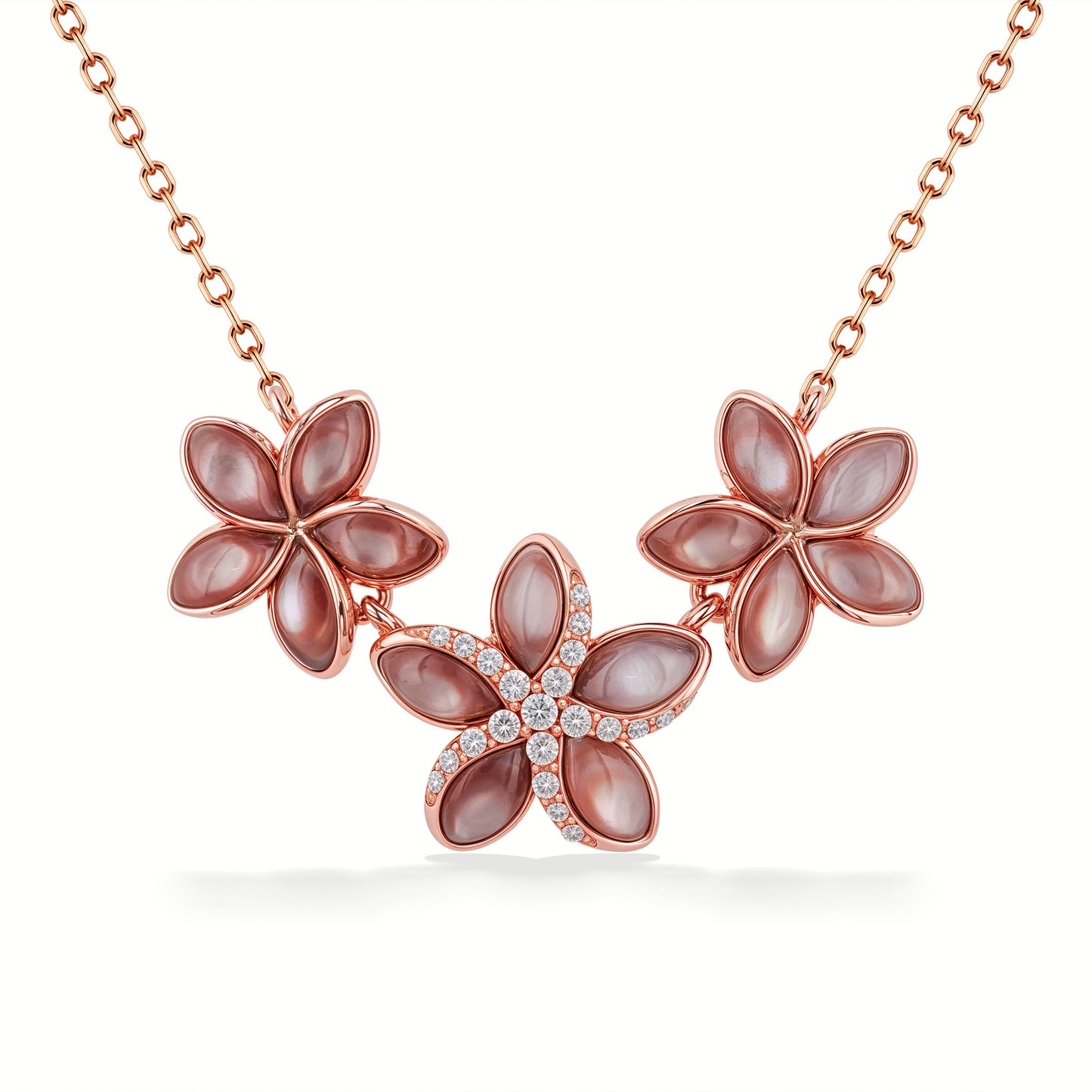 Close up image of 3 plumerias with pink mother of pearl inlay set in rose gold. Middle plumeria with diamonds. Item No. 45156