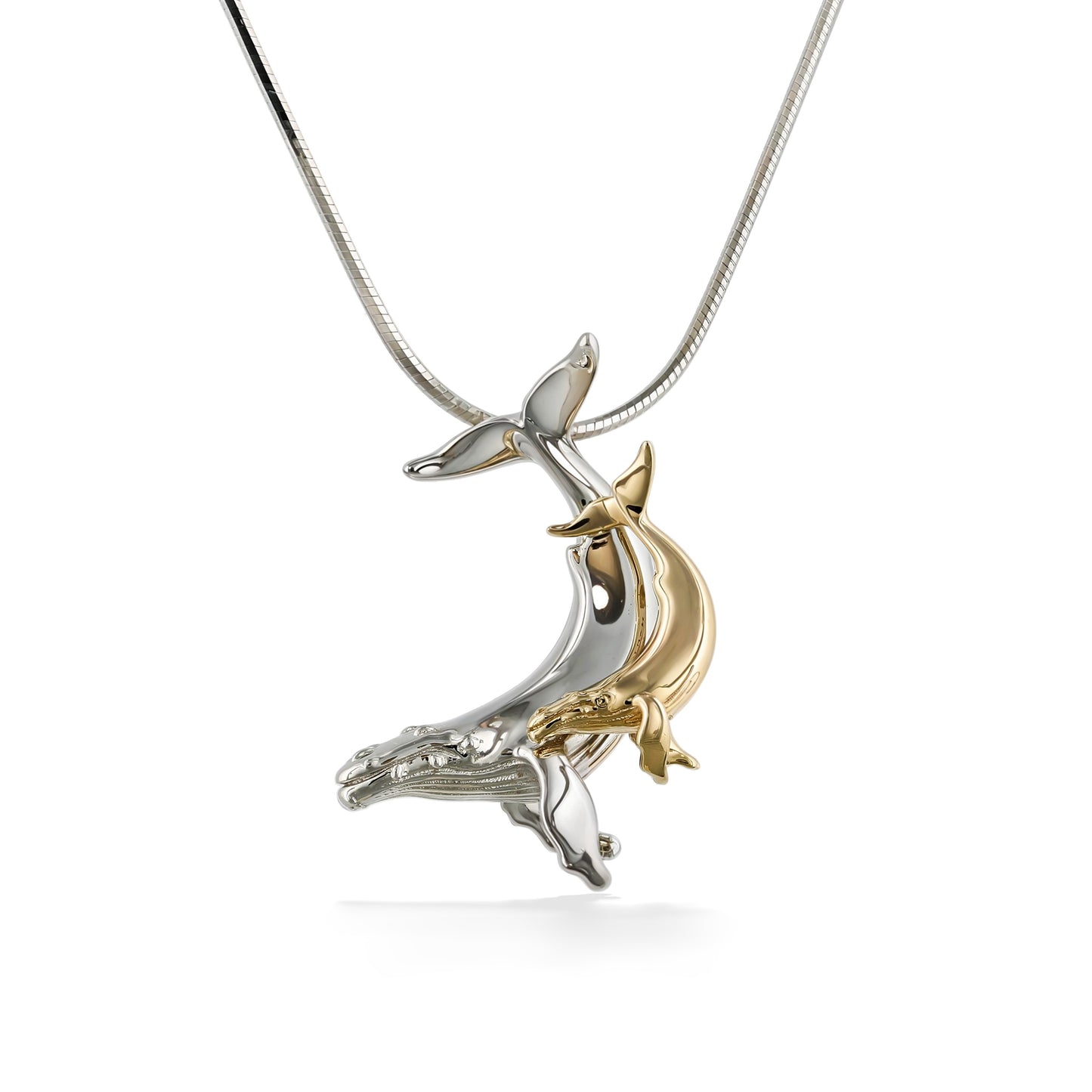 A two-tone pendant of a humpback whale mother and calf in polished 14k yellow gold and sterling silver. Item No. 45254