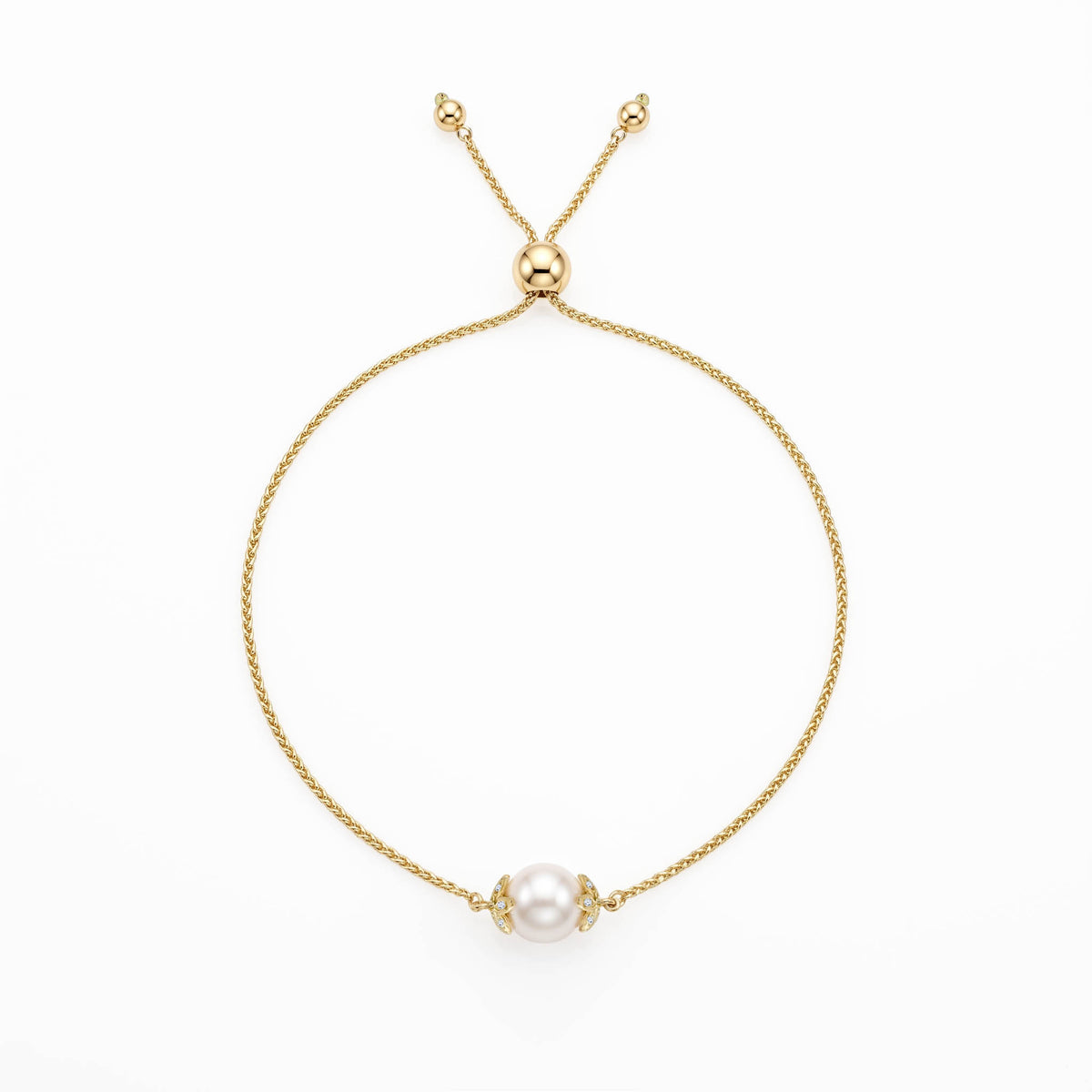14K yellow gold flower bolo bracelet with a single 7mm white Akoya pearl and diamond accents. Item No. 45443