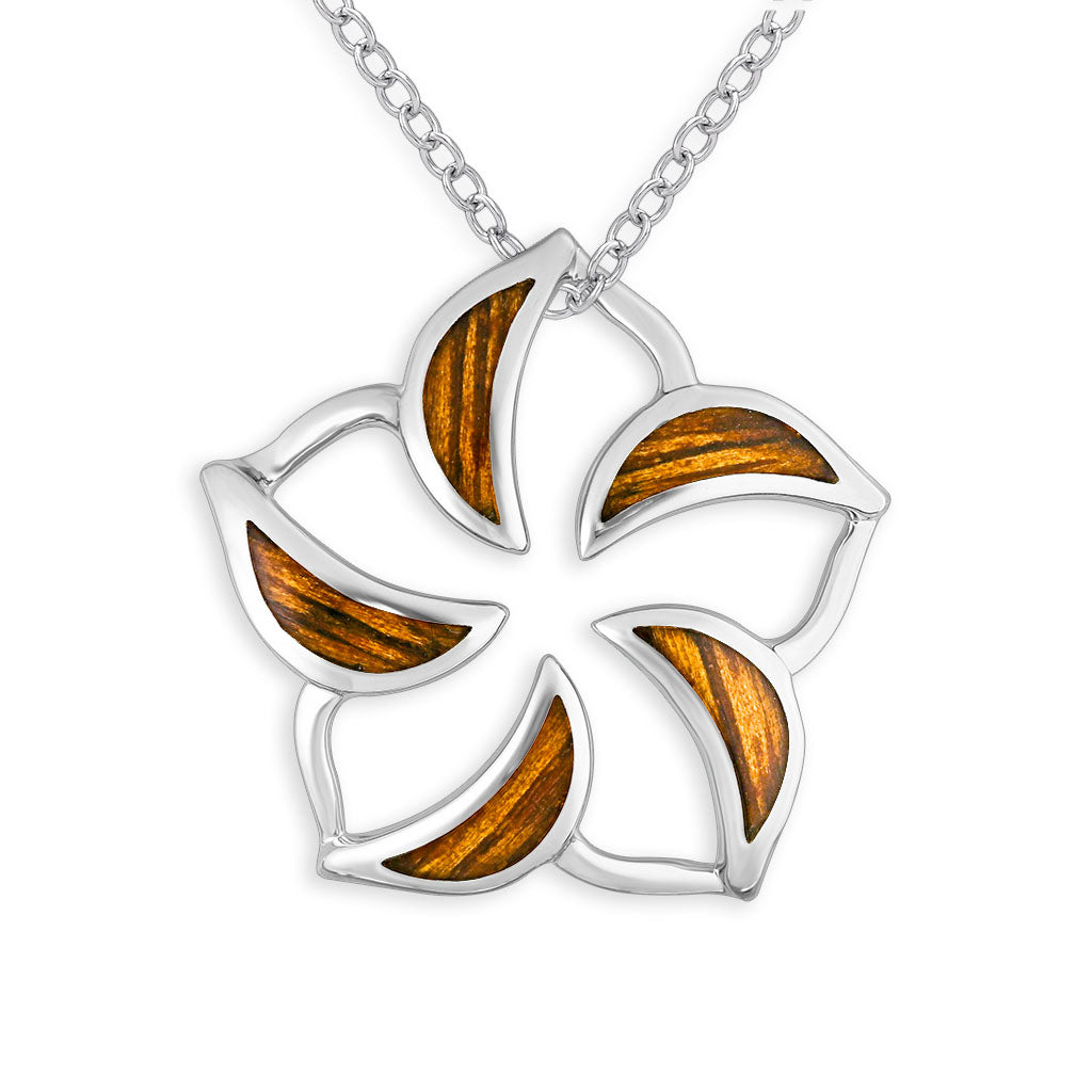 Delicate, symmetrical plumeria form pendant in sterling silver with hollow center, lined by koa wood inlay. Item No. 766578