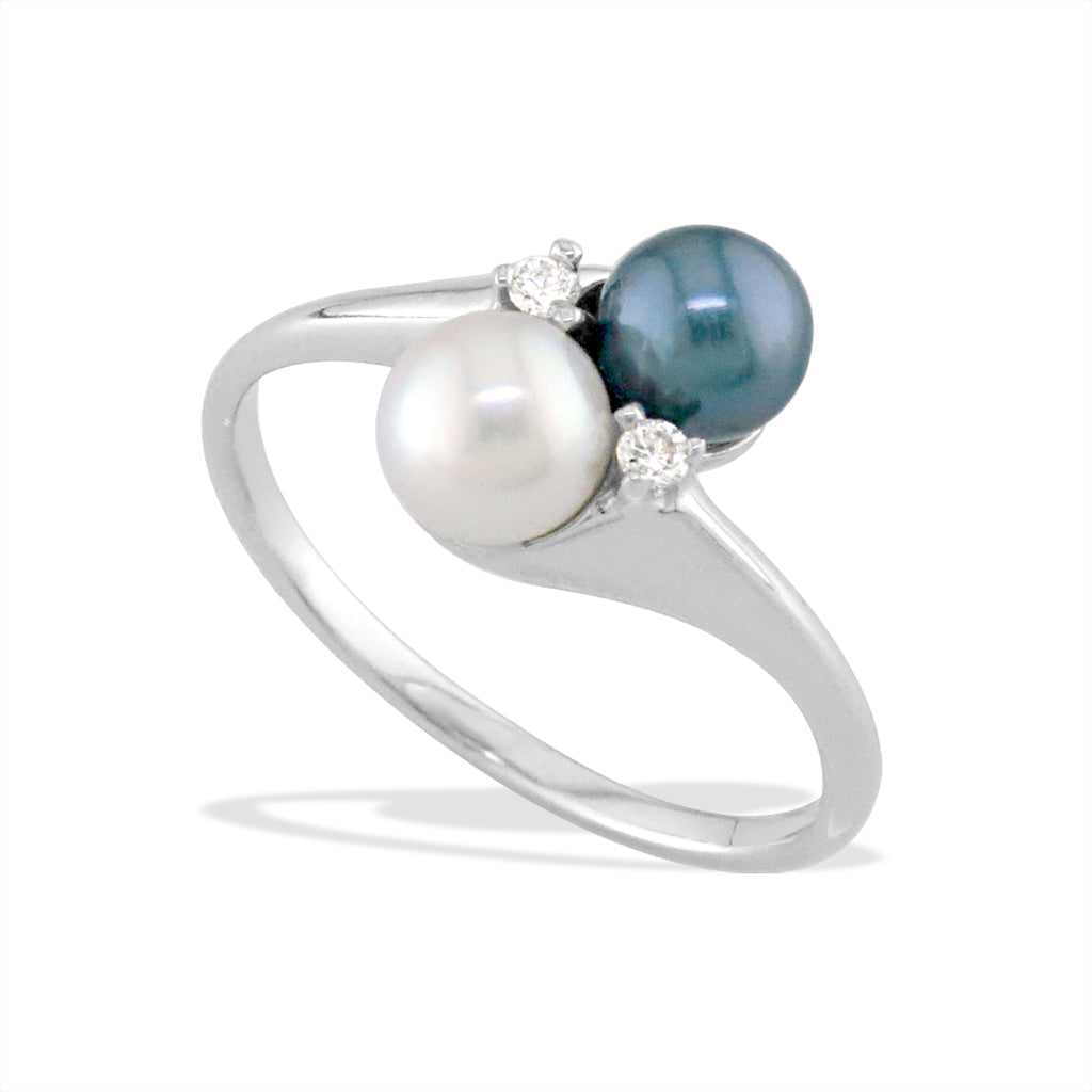 White gold ring featuring a white and deep blue Akoya pearl paired with diamond accents on a polished band. Item No. 13642