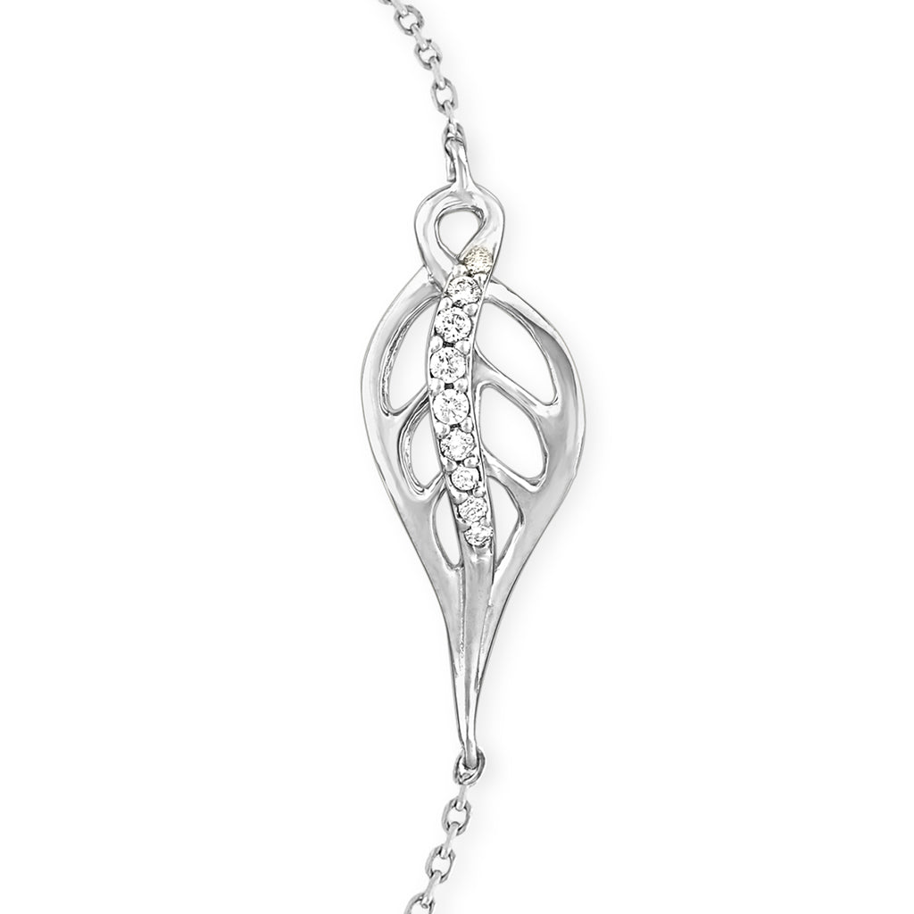 Detailed view of a white gold leaf-inspired bracelet centerpiece highlighting a diamond-lined curve. Item No. 41895