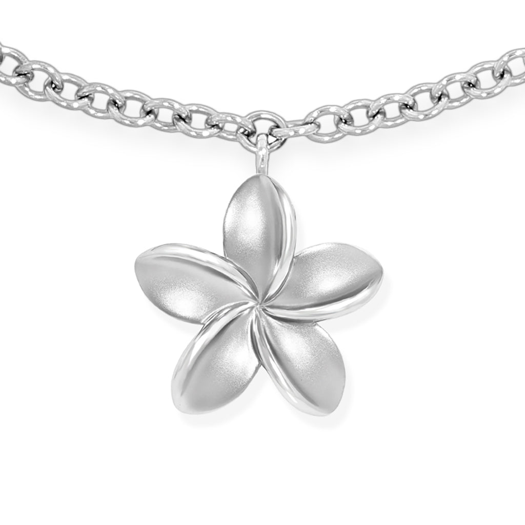 Detailed view of the sterling silver plumeria charm with matte finish and polished inner edges. Item No. 43036