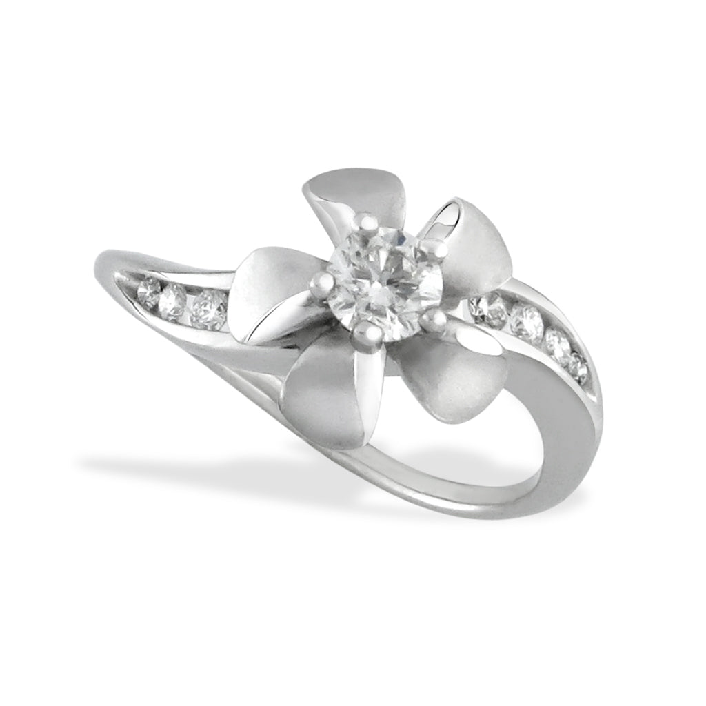 Large plumeria with a 0.25ct center diamond set on a white gold wavy designed ring with channel-set diamonds. Item No. 41841