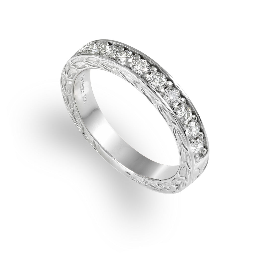 White gold ring with hand engraved maile scroll all around and 0.50 ctw of diamonds embedded on the top half. Item No. 43157