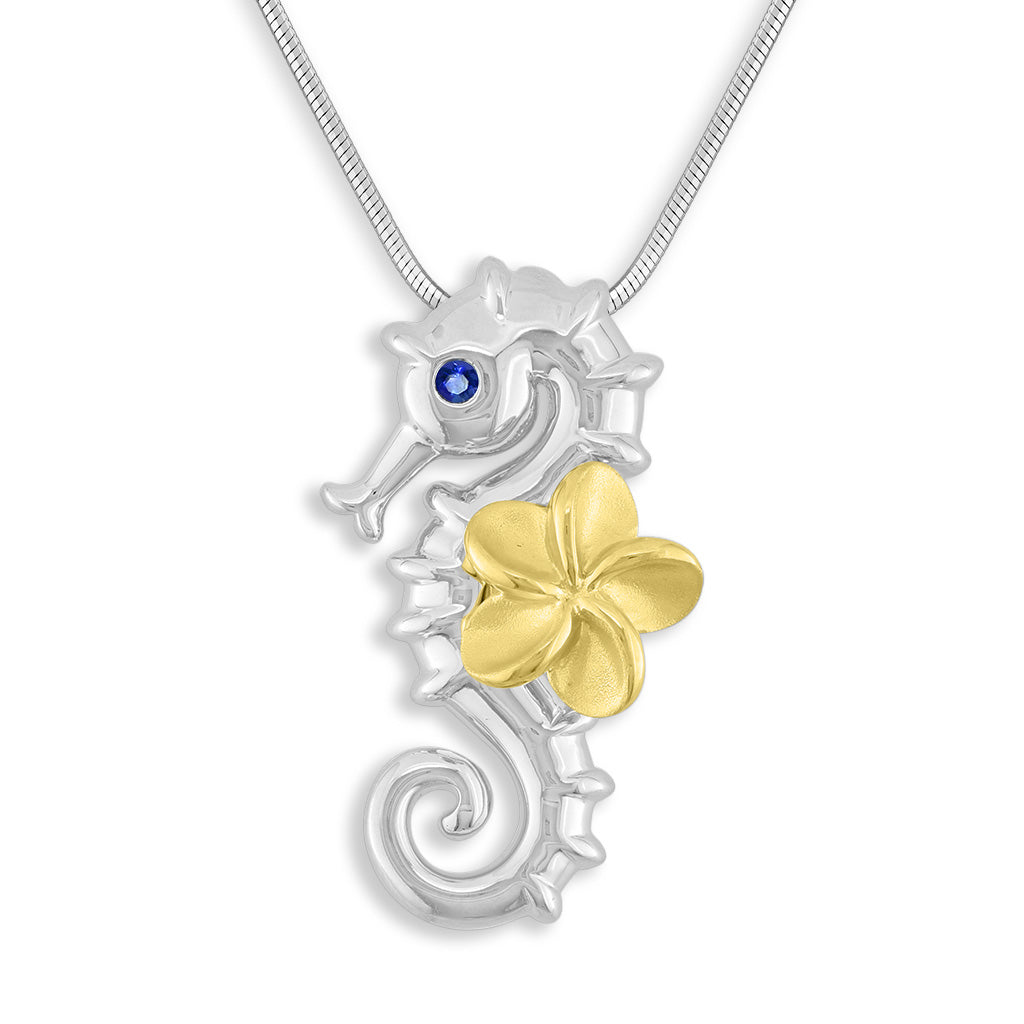Detailed sterling silver seahorse pendant with blue sapphire eyes & 14k yellow gold plumeria on its back. Item No. 43493