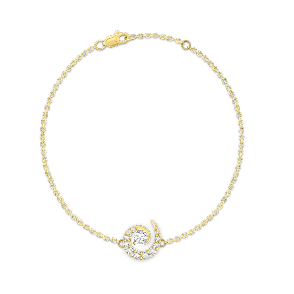 Wave-inspired bracelet with a swirl-shaped diamond center charm on a fine chain, made in 14k yellow gold. Item No. 43540