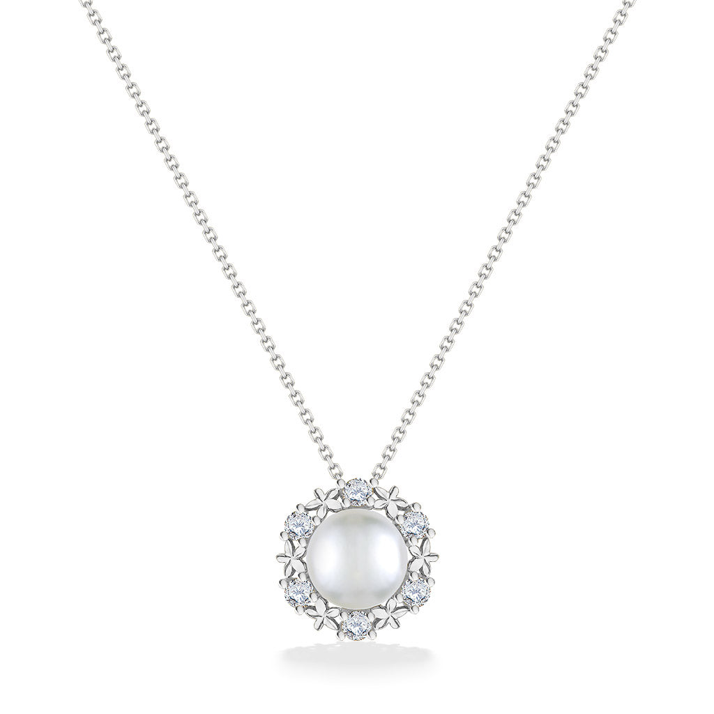 Front view of white gold pearl pendant showcasing diamond accents arranged in a plumeria-style halo. Item No. 44308
