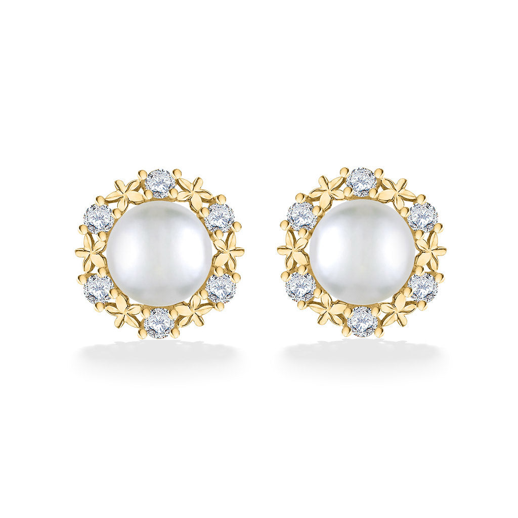 Yellow gold stud earrings featuring white Akoya pearls framed by a sparkling plumeria-inspired diamond halo. Item No. 44309