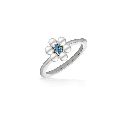 Flower ring with white freshwater pearls forming petals around a blue topaz gemstone on silver band. Item No. 44496