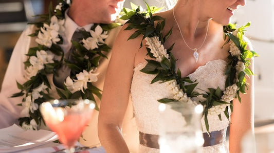 Hawaiian themed wedding, couple with leis sitting on table, Na Hoku jewelry