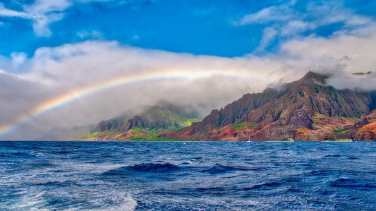 Rainbow over ocean and mountain coastline
