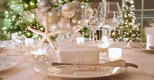 Decorative table setting with Christmas tree in the background