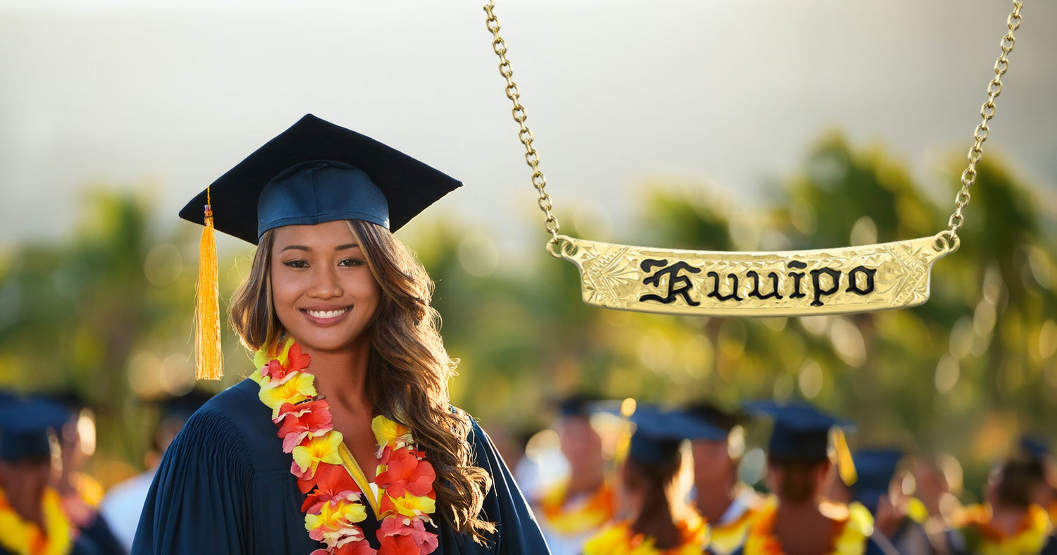 Graduating student wearing a cap and gown surrounded by people in a celebratory setting. Na Hoku 'Kuuiipo' necklace.
