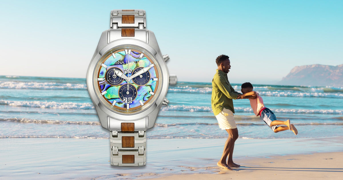 Na Hoku watch with Koa and Abalone inlay against beach background with a father playing with his son