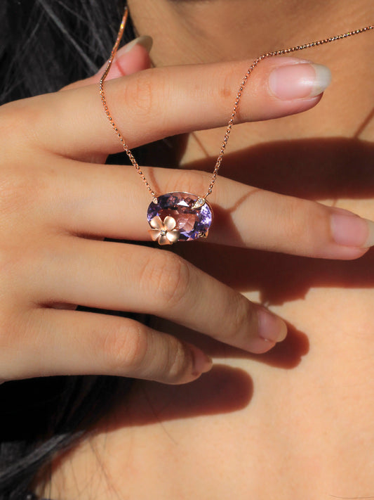 Model wearing a necklace with a purple Amethyst and rose gold plumeria and diamond accents - 774226