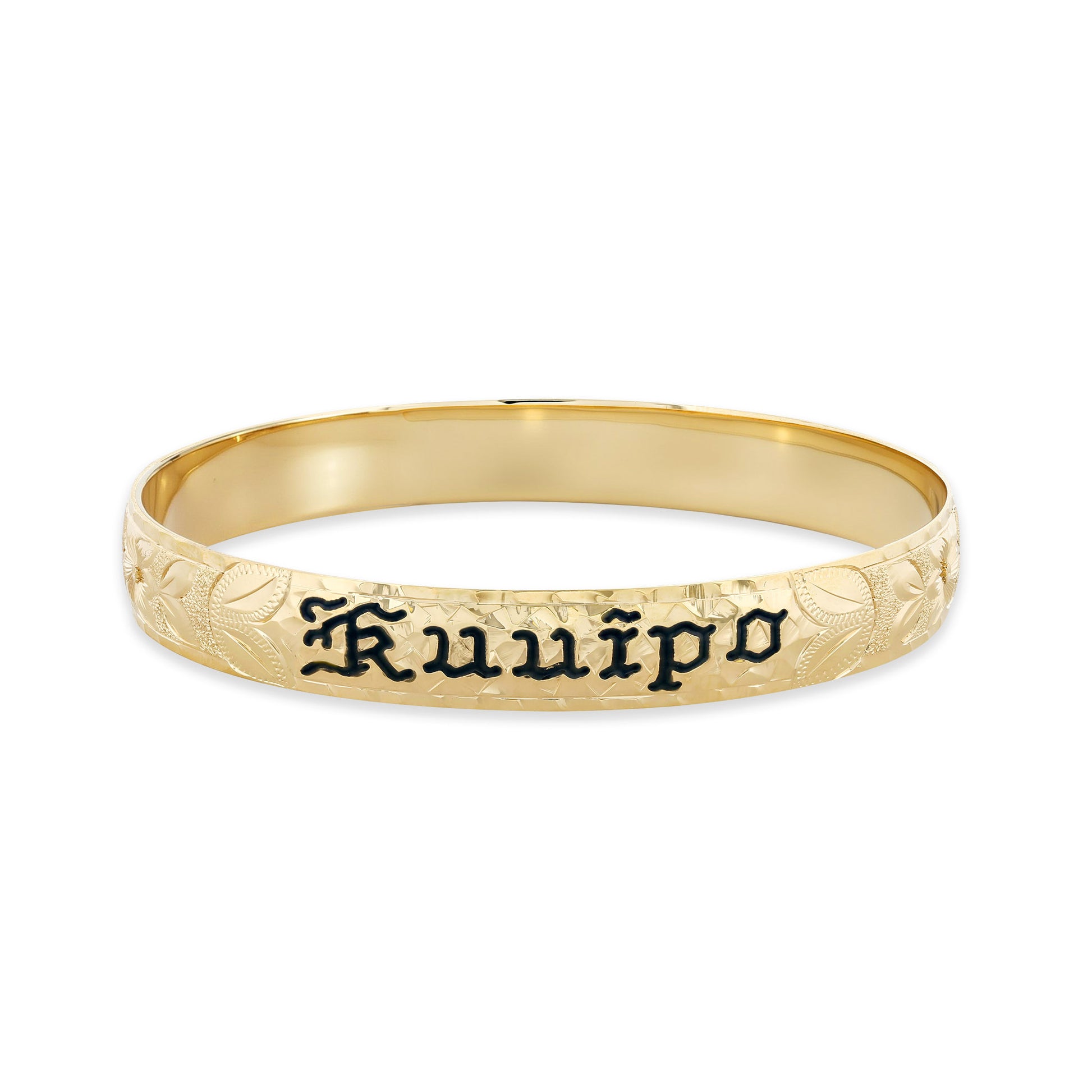 Bold yellow gold bangle displays engraved floral patterns and the name Kuuipo highlighted in black enamel. Item No. 60090