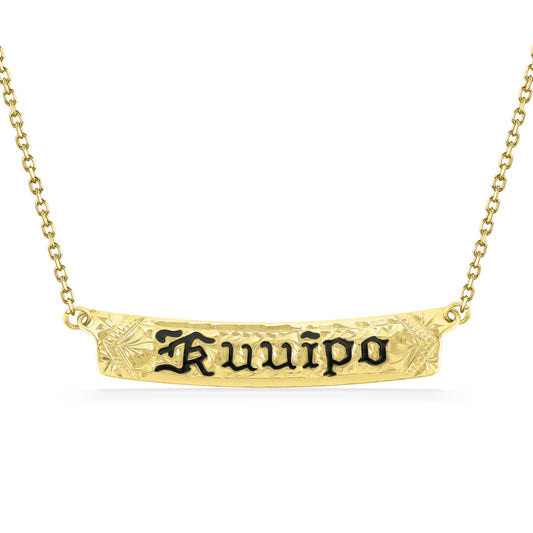 Centered on a gold chain, the engraved Kuuipo nameplate features detailed floral carving & black enamel text. Item No. 60140