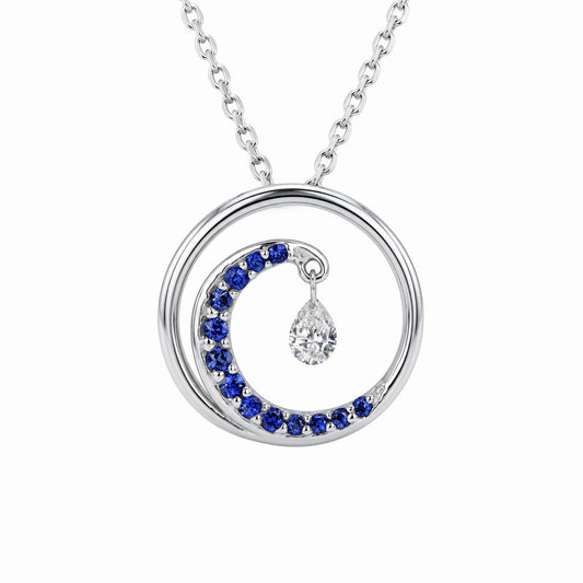 Small wave-like pendant in 14k white gold with a blue-sapphire accented crest & suspended shimmer diamond. Item No. 40150