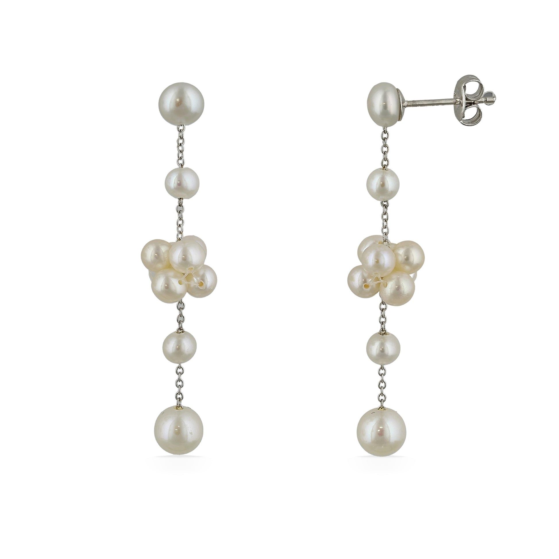 A pair of dangling earrings made with cascading white freshwater pearls connected by delicate silver chains. Item No. 700693