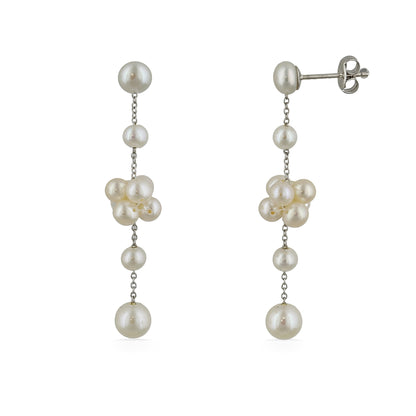 A pair of dangling earrings made with cascading white freshwater pearls connected by delicate silver chains. Item No. 700693