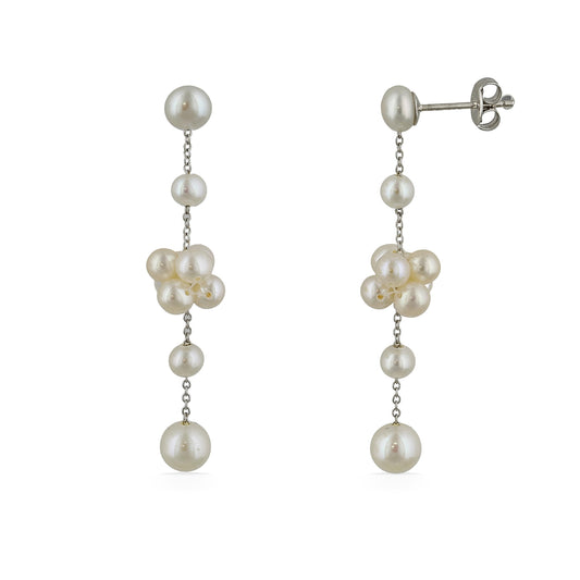 A pair of dangling earrings made with cascading white freshwater pearls connected by delicate silver chains. Item No. 700693