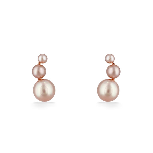 Graduated pearl stud earrings feature three softly glowing pearls stacked vertically in warm rose gold. Item No. 700677