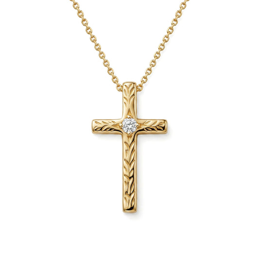 A 14K yellow gold cross pendant adorned with maile scroll engraving and a 0.02 carat diamond center. Item No. 40445