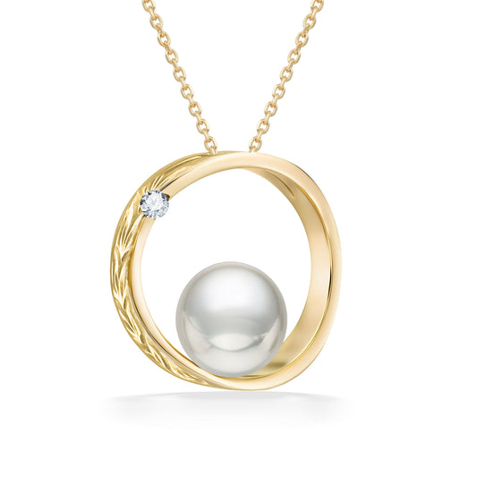 Circular yellow gold moon and star scroll cradles a 7mm white Akoya pearl with 0.02 carat diamond accent. Item No. 43162