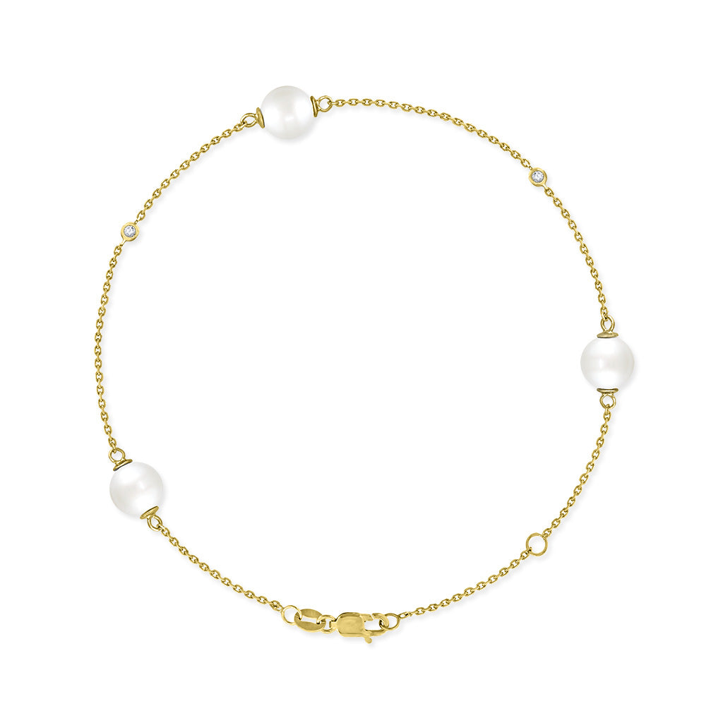 Yellow gold bracelet with 3 white Akoya pearls and bezel-set diamond accents arranged along a delicate chain. Item No. 43313