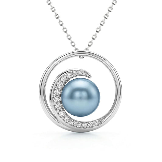 White gold pendant necklace with a blue Akoya pearl framed by a curved diamond-accented wave design. Item No. 43051