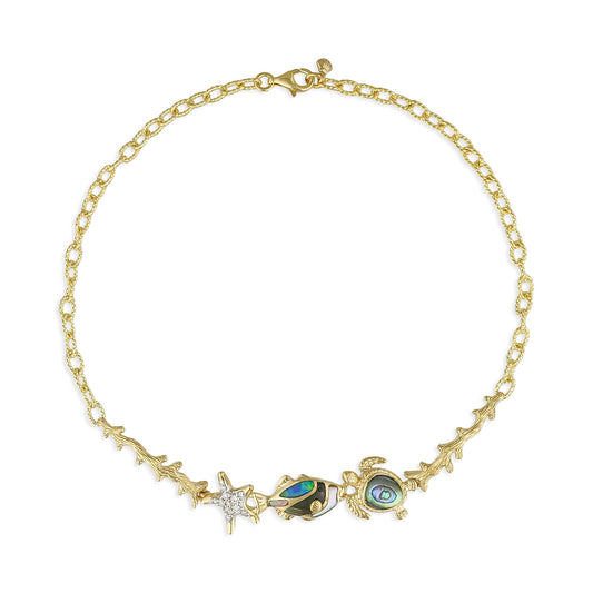 Gold textured link bracelet with a diamond starfish charm, fish & turtle charms with inlay between gold coral. Item No. 45200