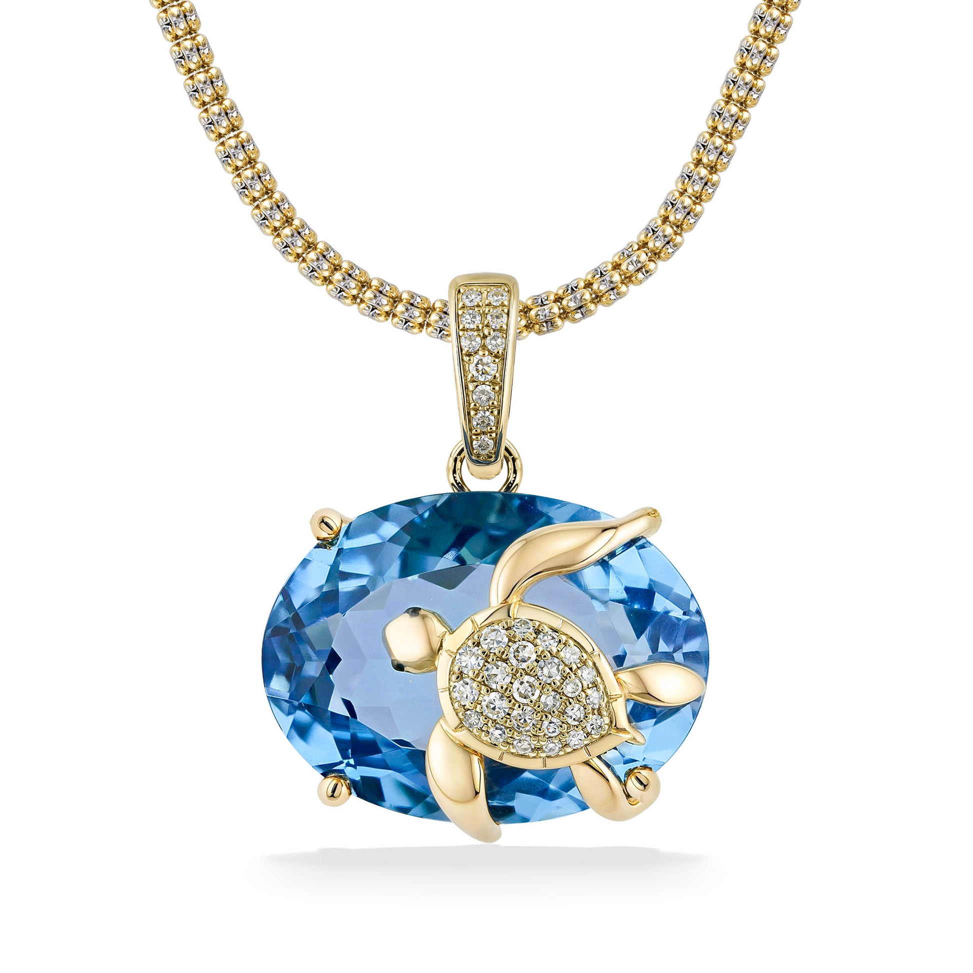 Diamond studded yellow gold honu on a large blue topaz, hung on a gold pavé-set enhancer bail. Item No. 774016