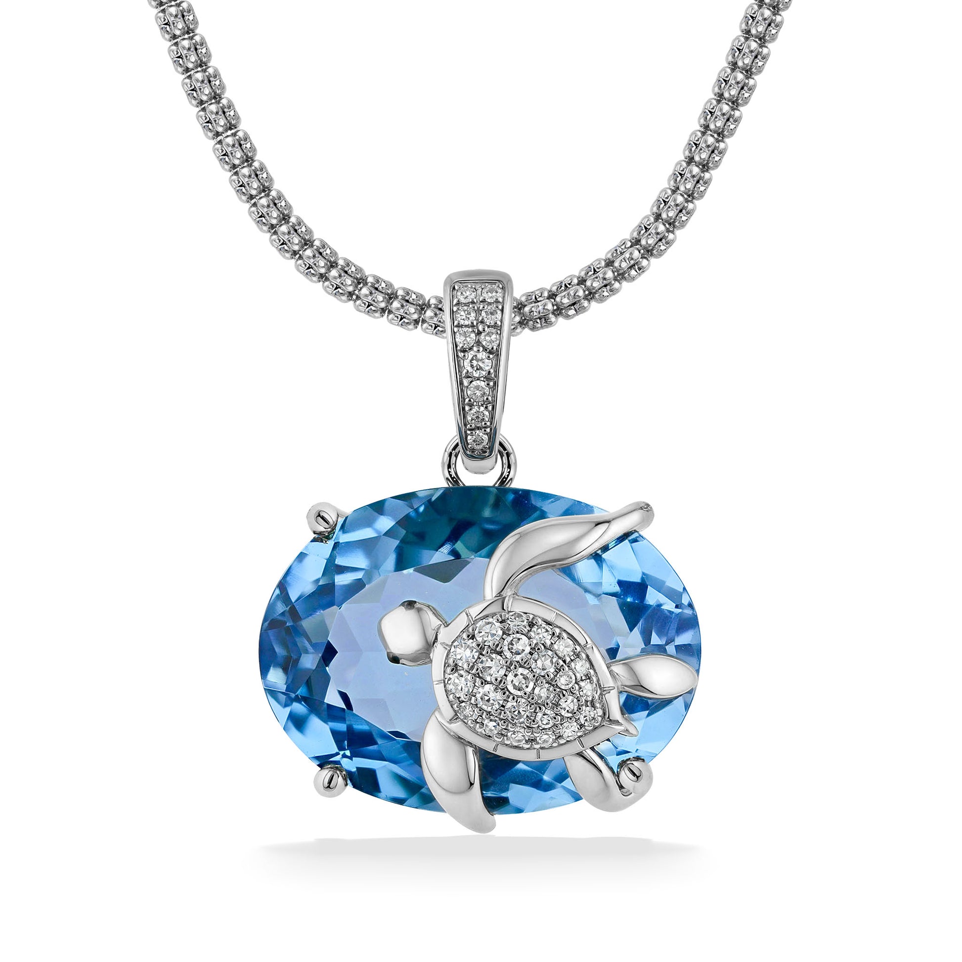 Pendant featuring a diamond sea turtle resting atop a 24.20 carat oval blue topaz with a pave-set bail. Item No. 774017