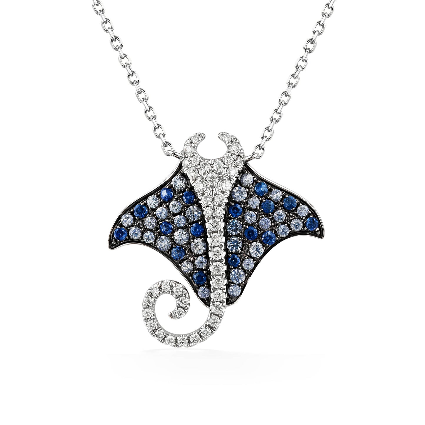 Manta ray pendant with blue sapphires and diamonds set in 14k white gold, hanging from a white gold chain. Item No. 774143