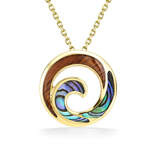 Sophisticated circle pendant with wave design, made in 14K yellow gold with abalone and koa wood inlay. Item No. 45273