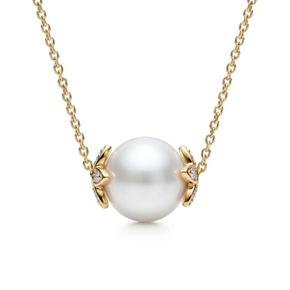 Round white akoya pearl slider necklace with 14k yellow gold flower endcaps, accented with diamonds. Item No. 45412