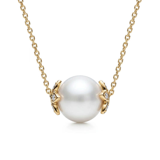 Round white akoya pearl slider necklace with 14k yellow gold flower endcaps, accented with diamonds. Item No. 45412