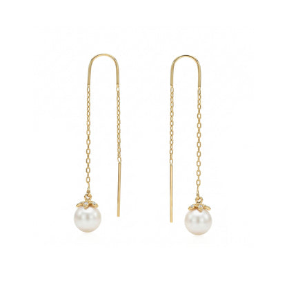 Yellow gold threader earrings with white akoya pearl and diamond set flower end caps. Item No. 45423